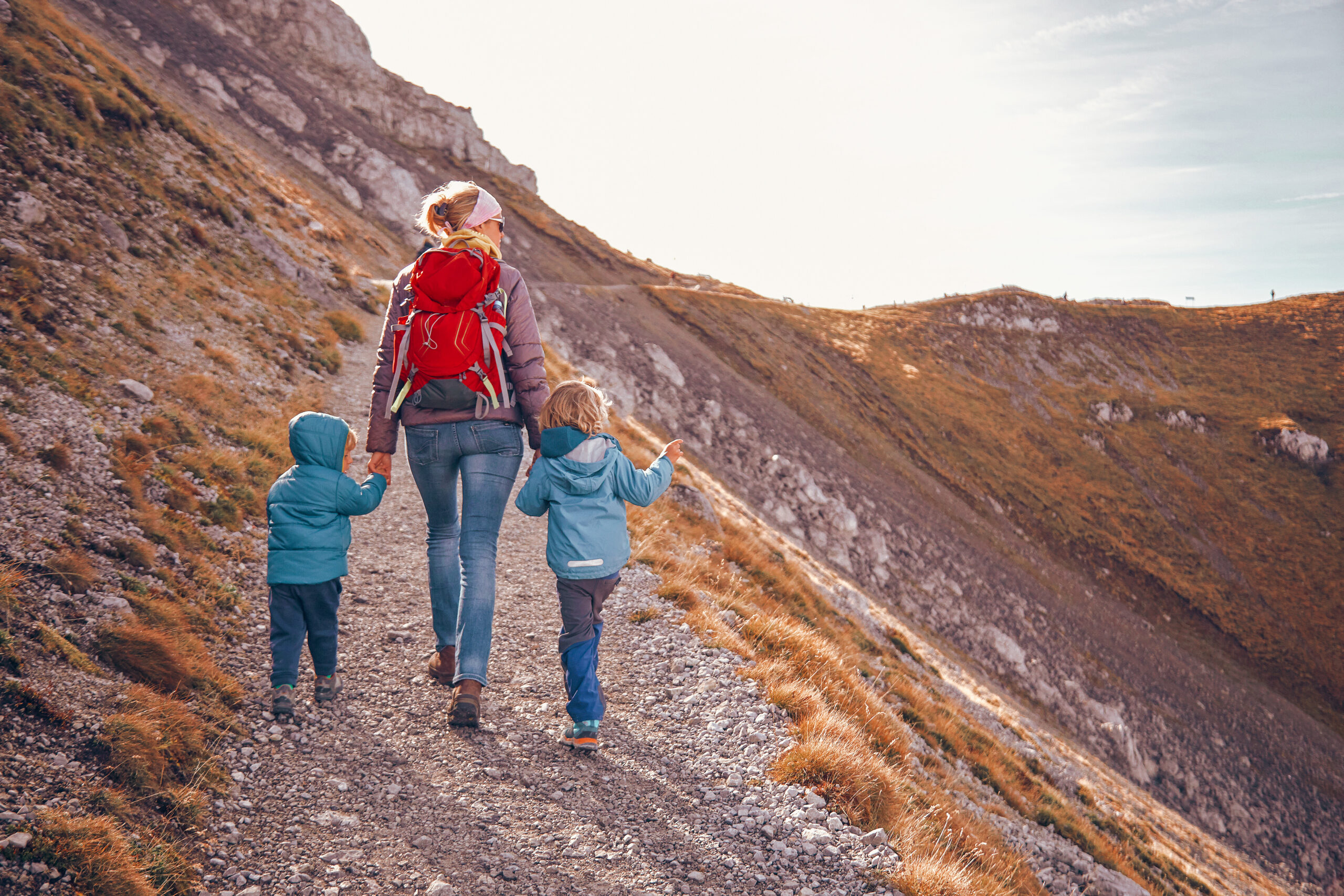 Family adventure high in the mountains at sunset